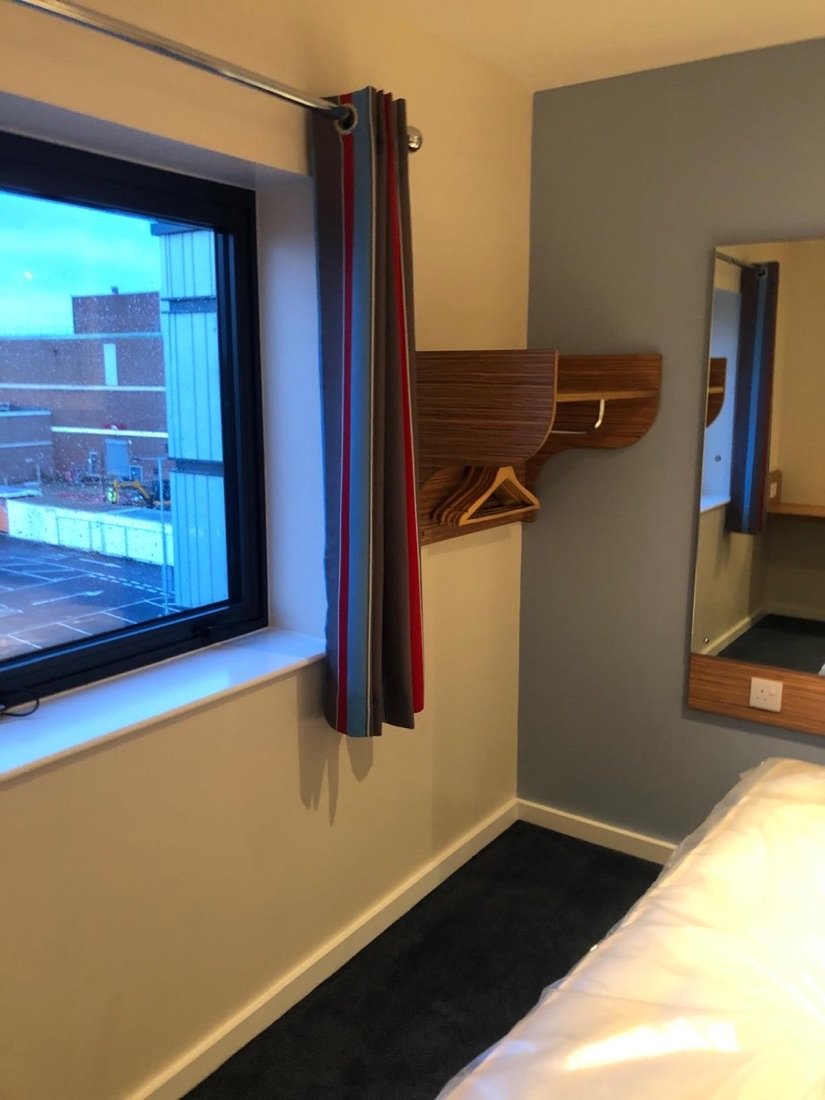 Refreshed hotel guest bedroom decorated by T & D Decorators
